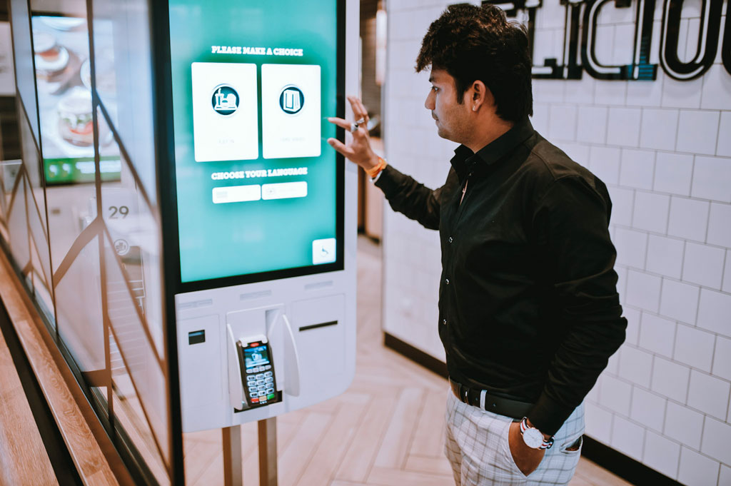 man using face-scanning kiosk