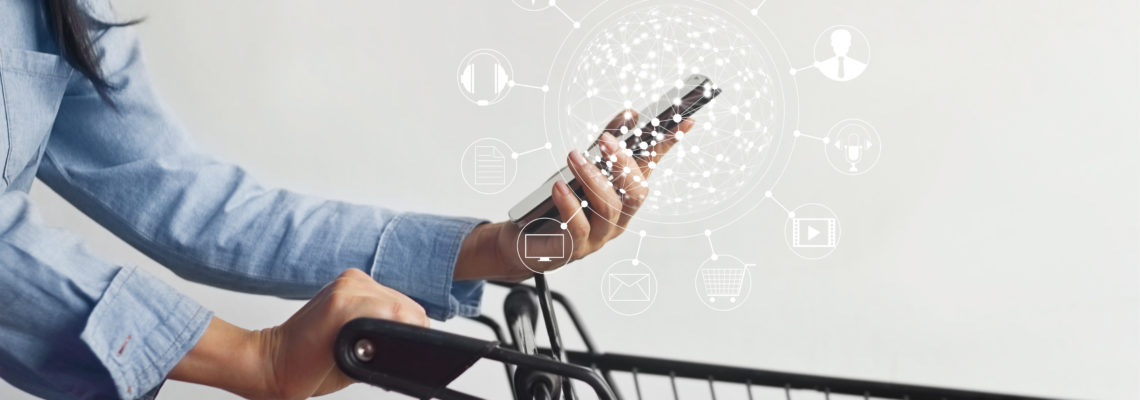 Omnichannel Retail and Grocery Checklist | Worldlink Integration Group | Woman using ominichannel options offered by a grocery or retail business with shopping cart and a unified customer experience