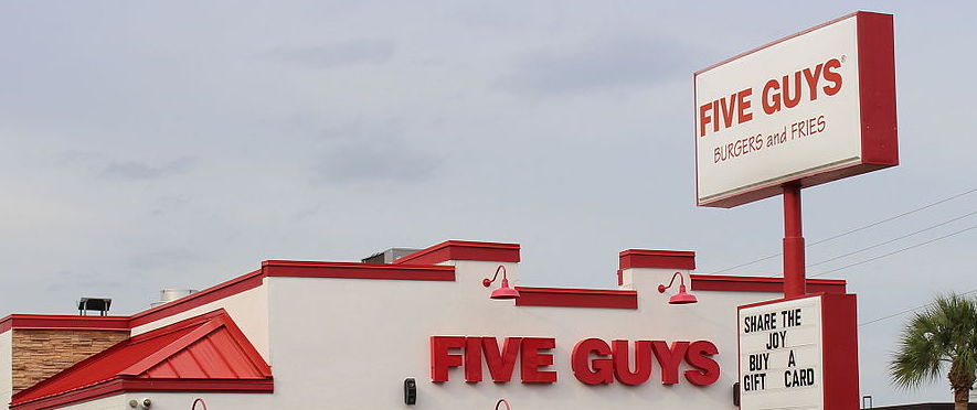 Five Guys Restaurant | Worldlink Integration Group | Image of Five Guys Restaurant in Merritt Island in Florida which is an aerial view of the restaurant with the logo appearing once on the sign and once on the facade of the restaurant