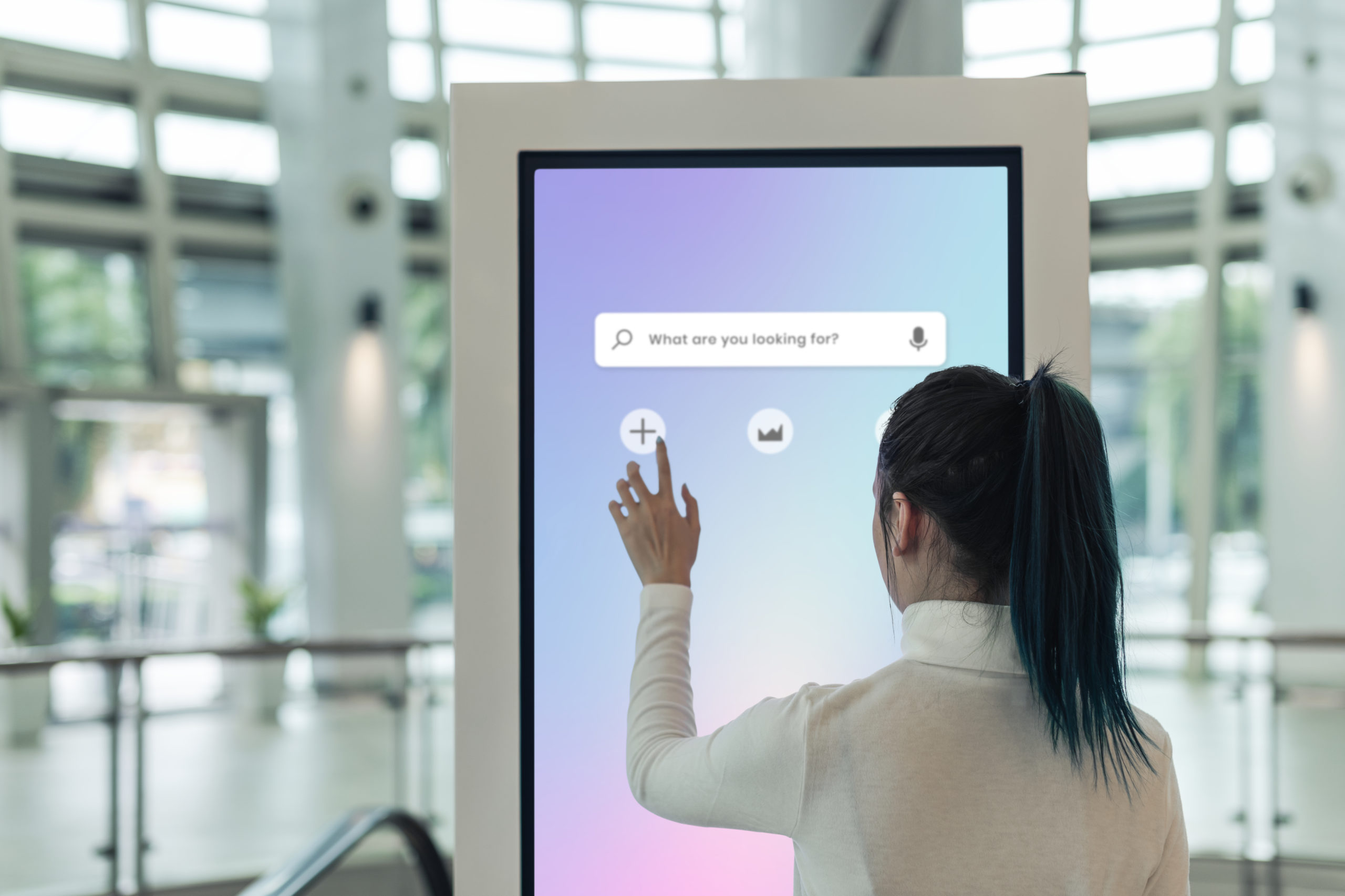 Woman using digital kiosk