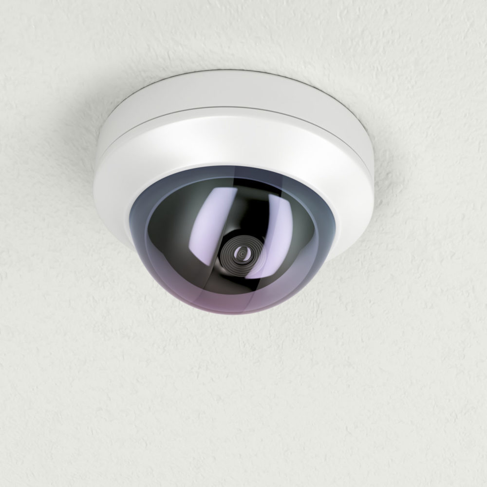 Surveillance camera attached on white ceiling